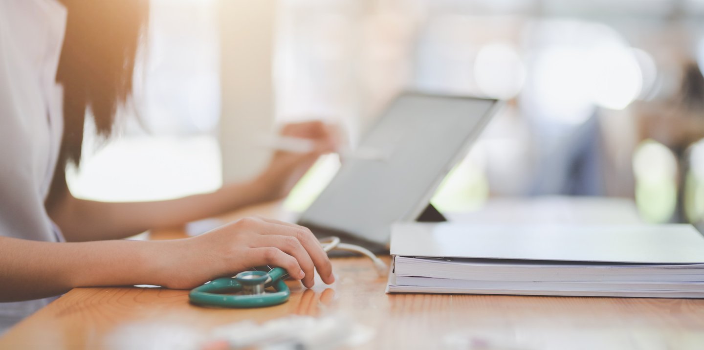 Crop doctor working on laptop in doctors office